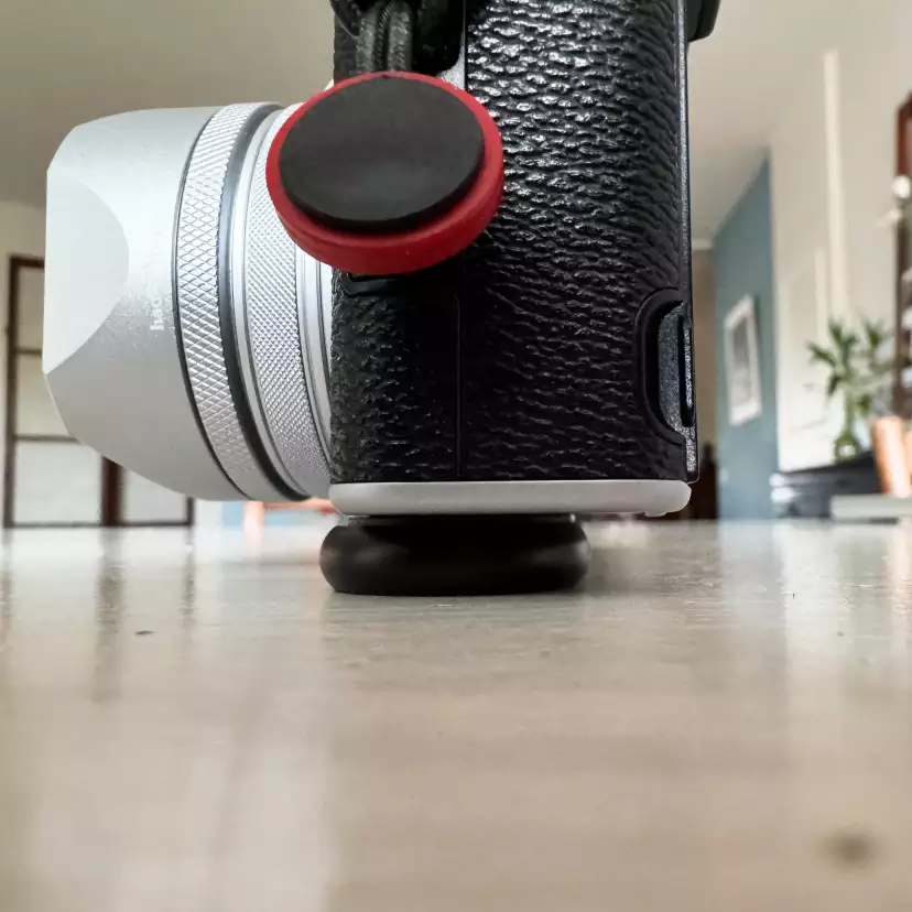 Fujifilm X100VI side view mounted with Peak Design's Micro Clutch overlapping in front
