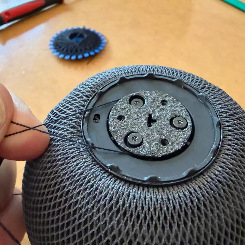 Finish securing the mesh draw string around the base plate