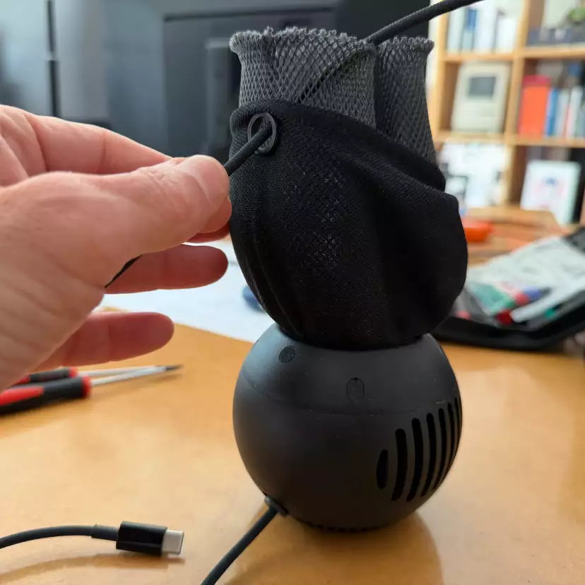 Move the fabric along the power cable. Do not try to pull the power plug out.