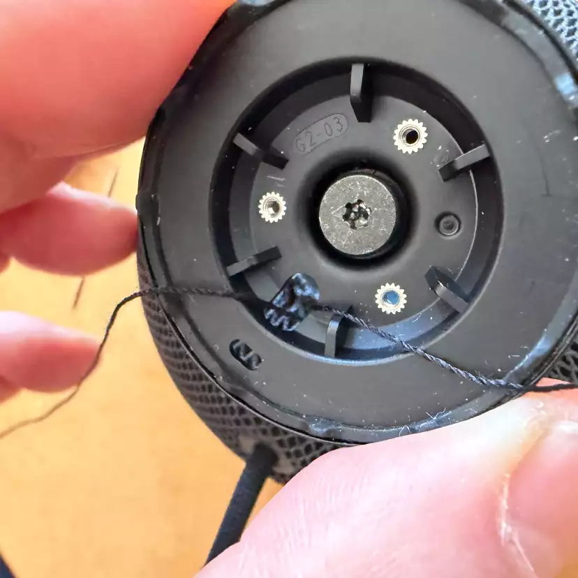 Thread the end of the draw string through the base plate