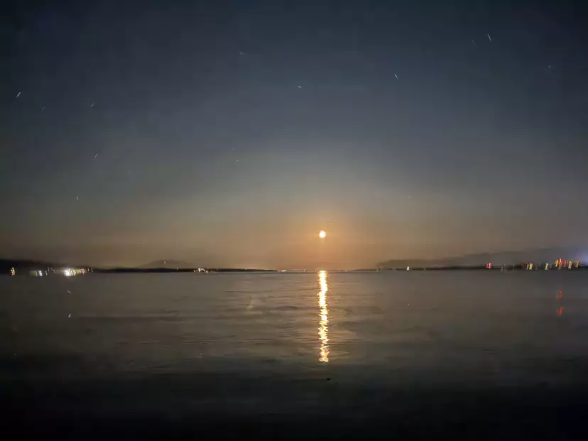A golden moon setting on the lake at 1am