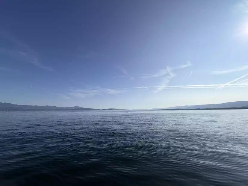 Wide blue sky horizon on blue lake