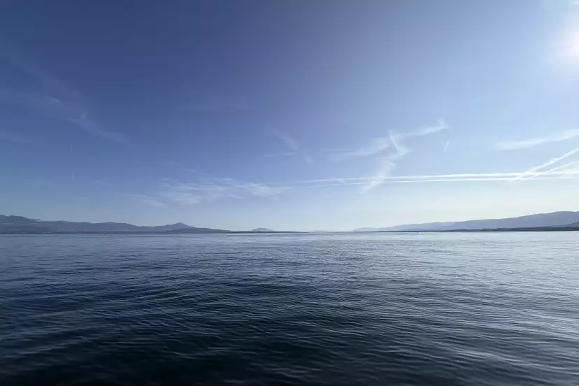 Wide blue sky horizon on blue lake