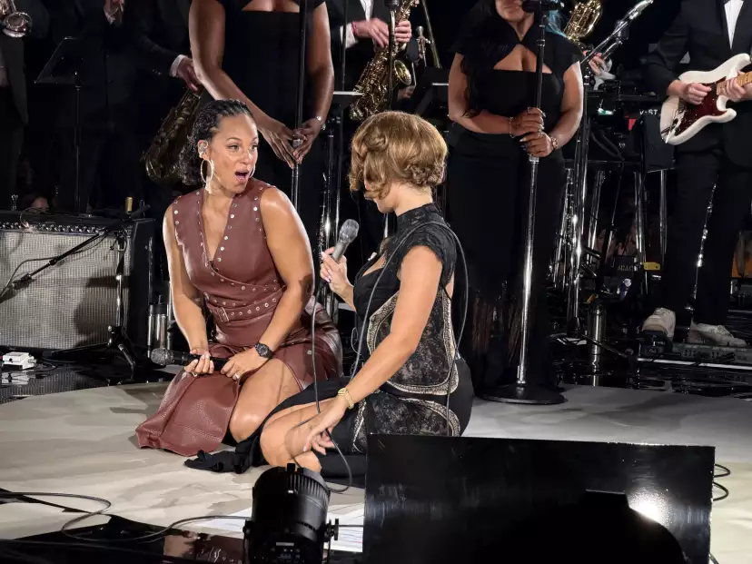 Alicia Keys and RAYE sitting on stage