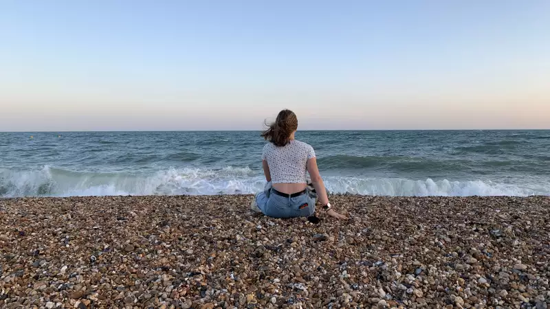 Emma sitting on the beach at Brighton