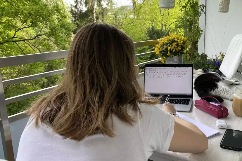 Emma studying maths on the balcony