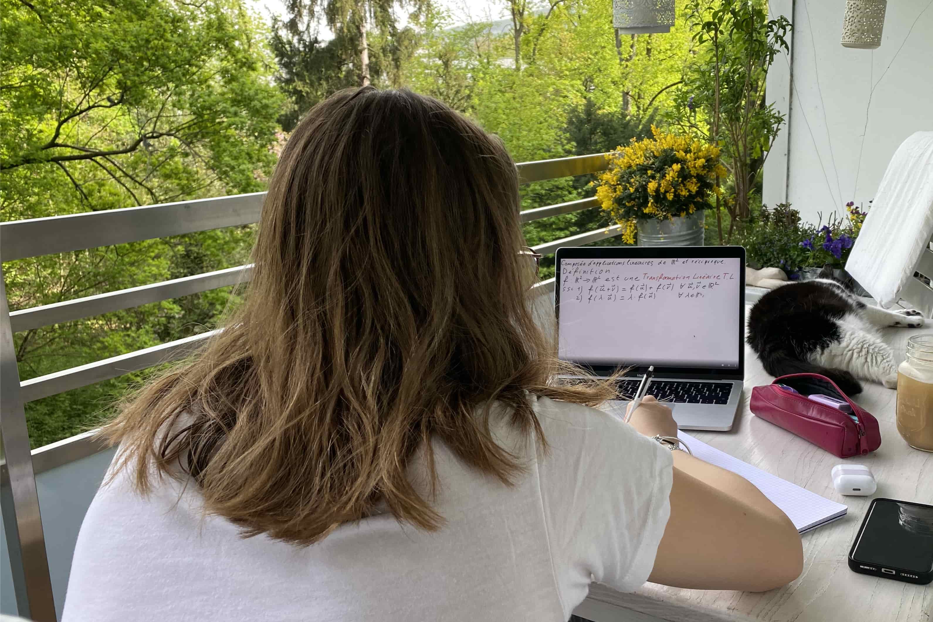 Emma studying maths on the balcony