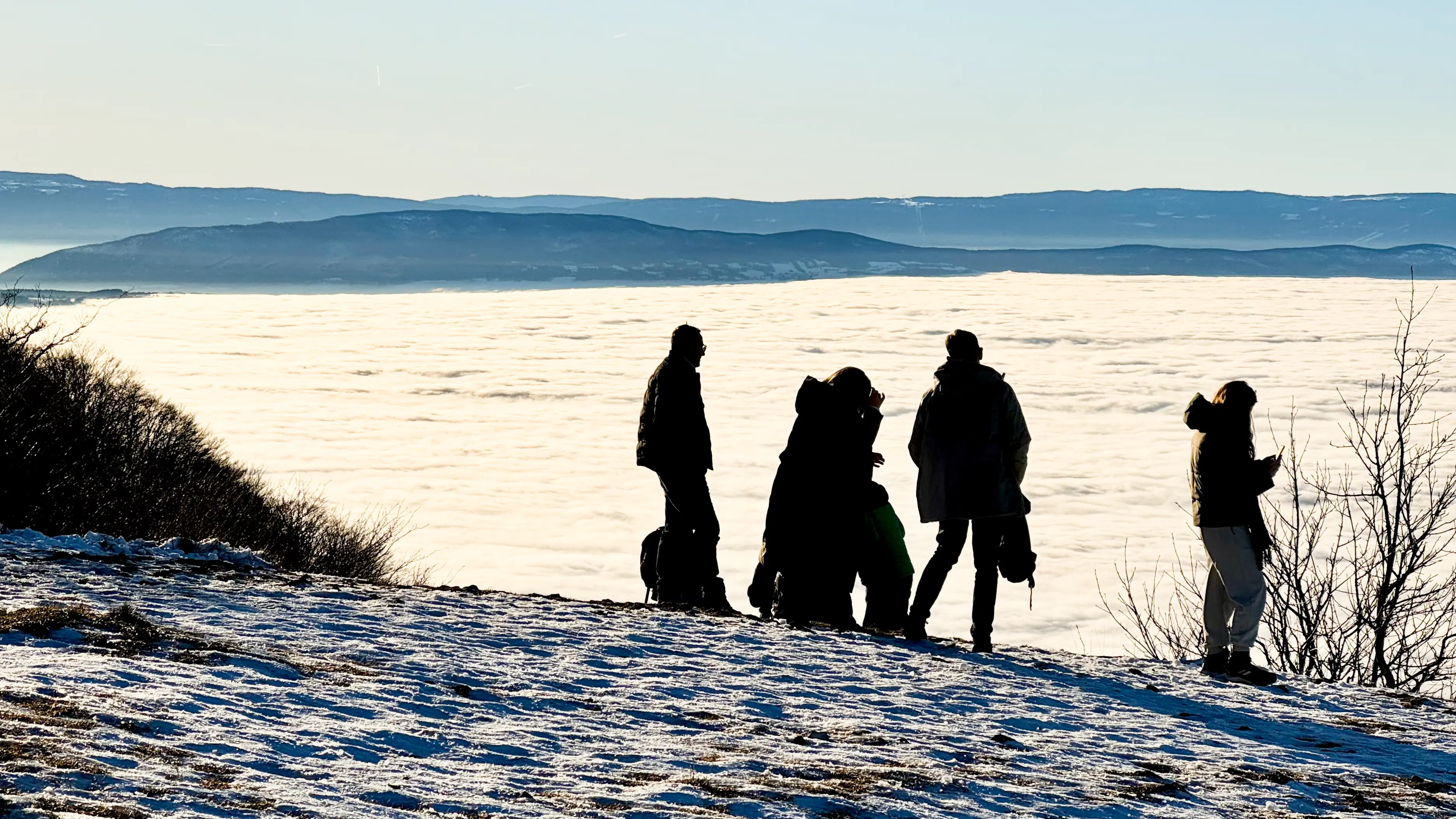 Silhouettes against the sea of cloud looking towards the Jura