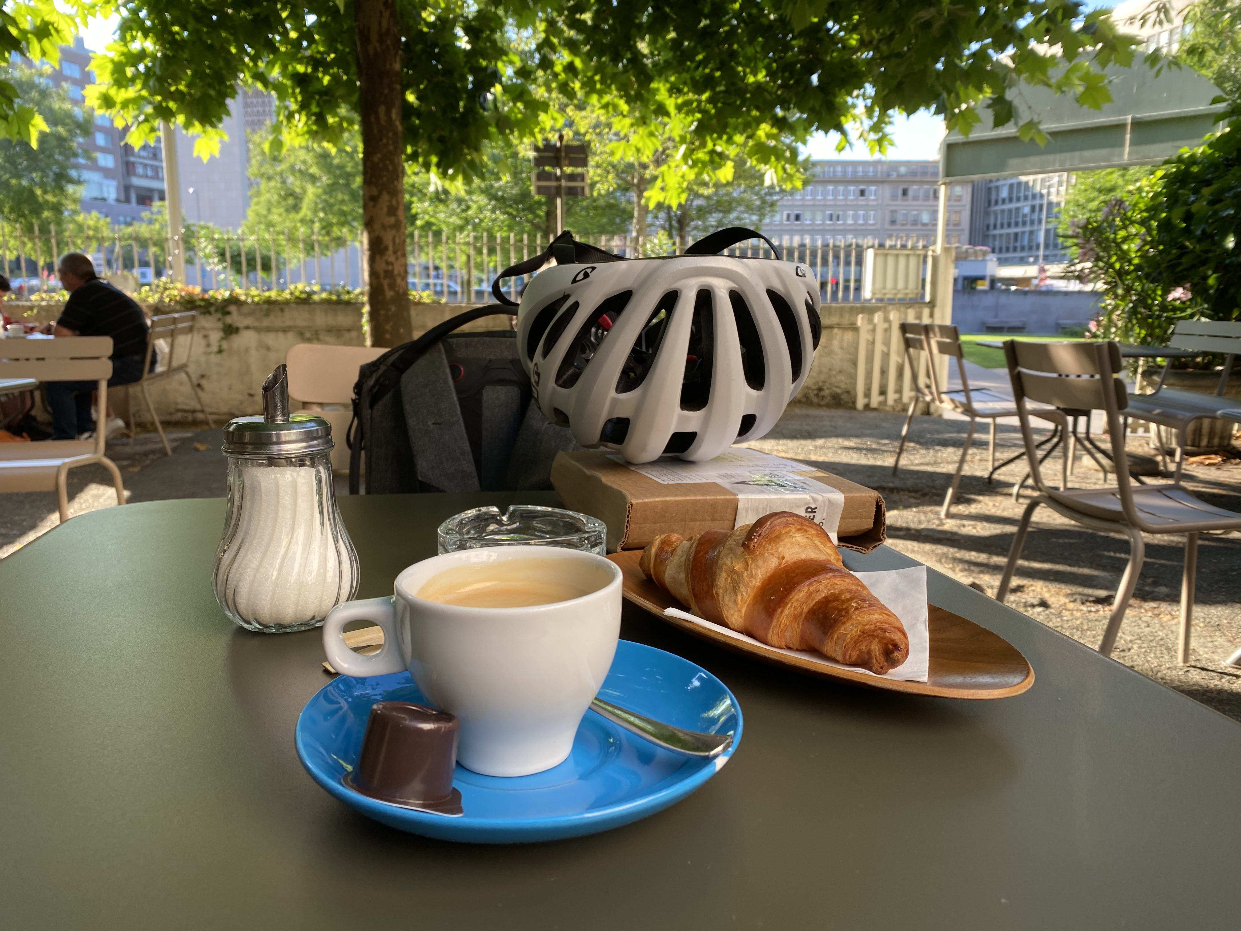 A coffe and croissant on a table on the terrasse of the Platane restaurant