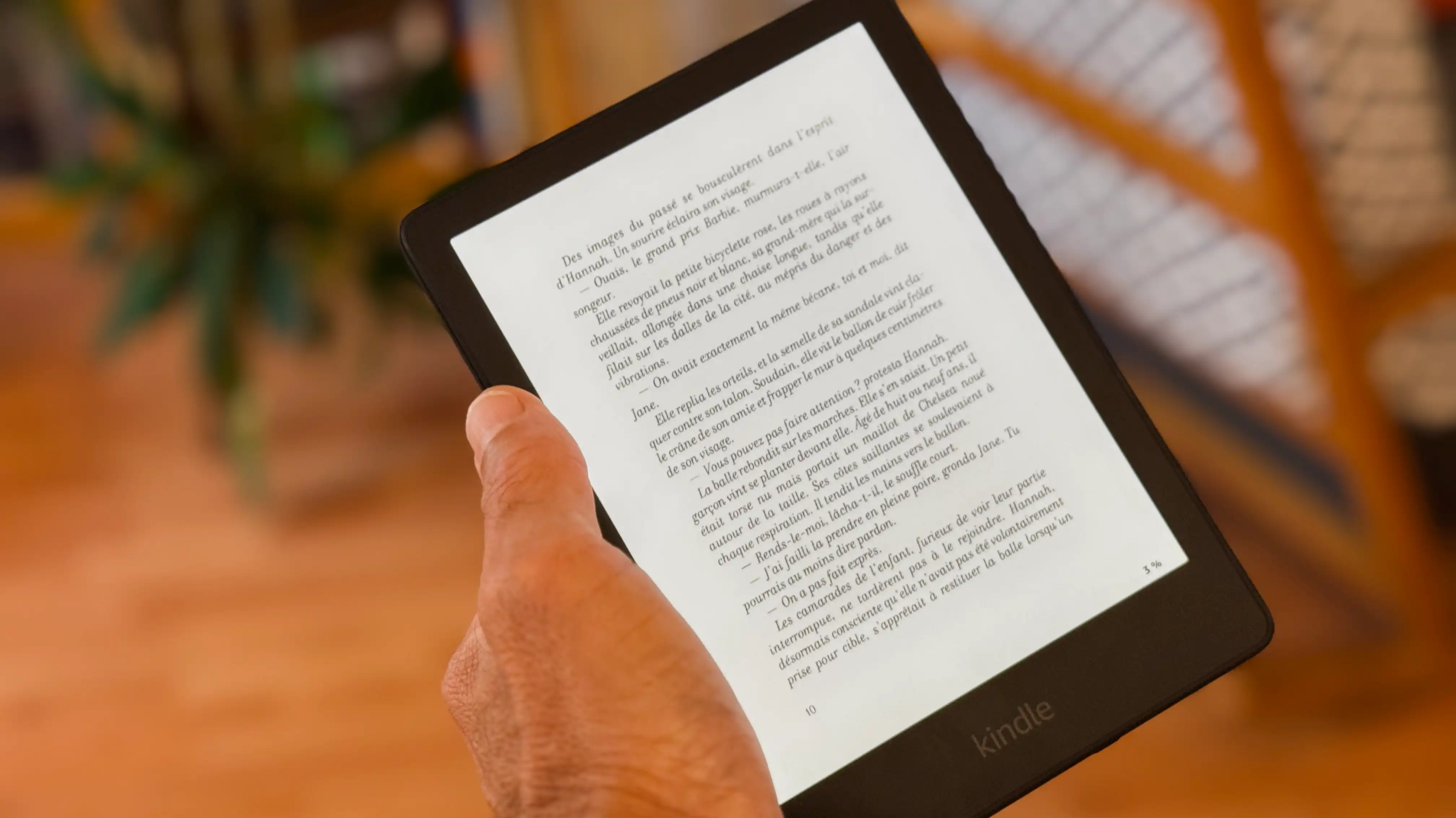 Kindle Paperwhite in my left hand with small text displayed