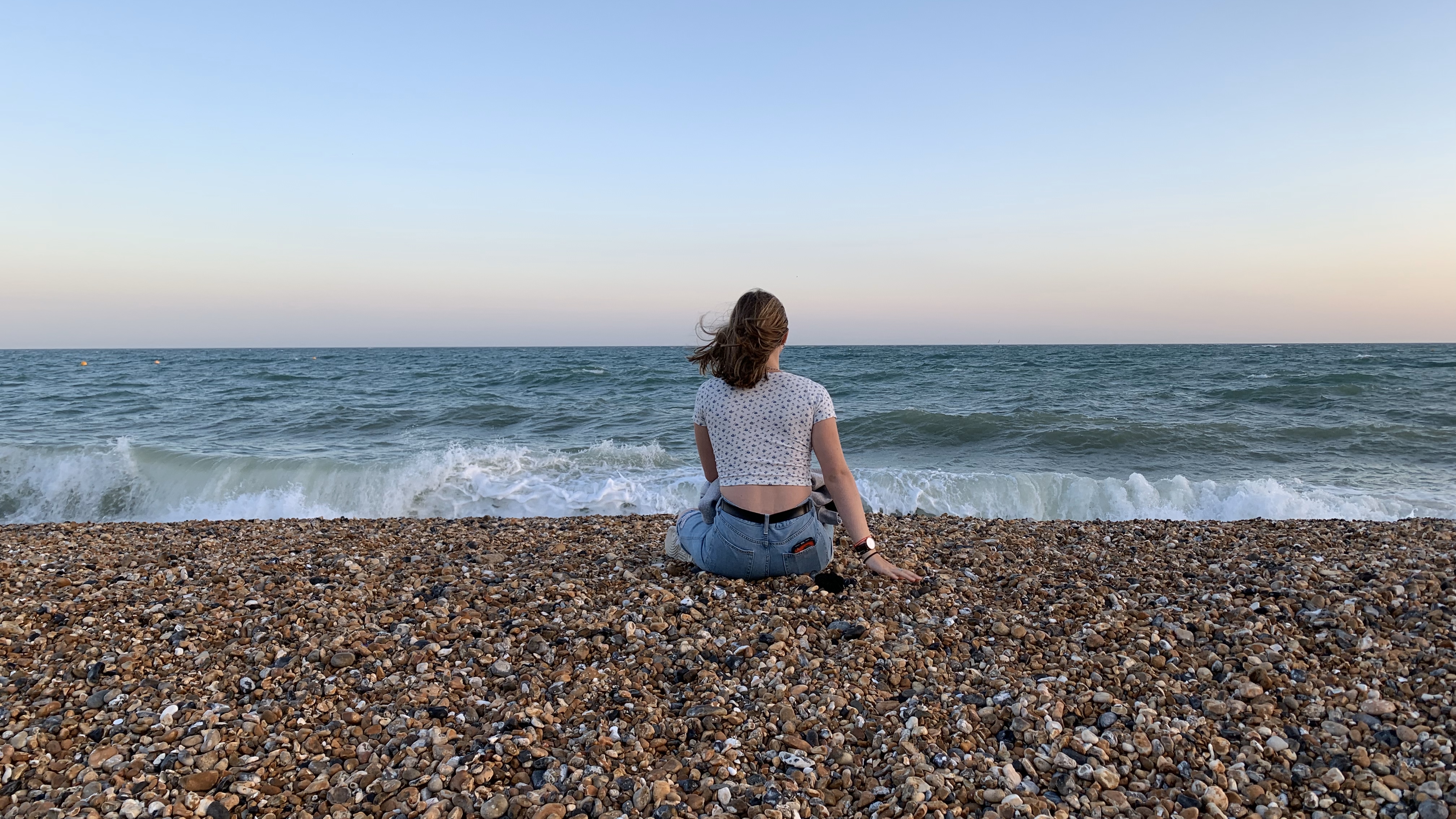 Emma sitting on the beach at Brighton