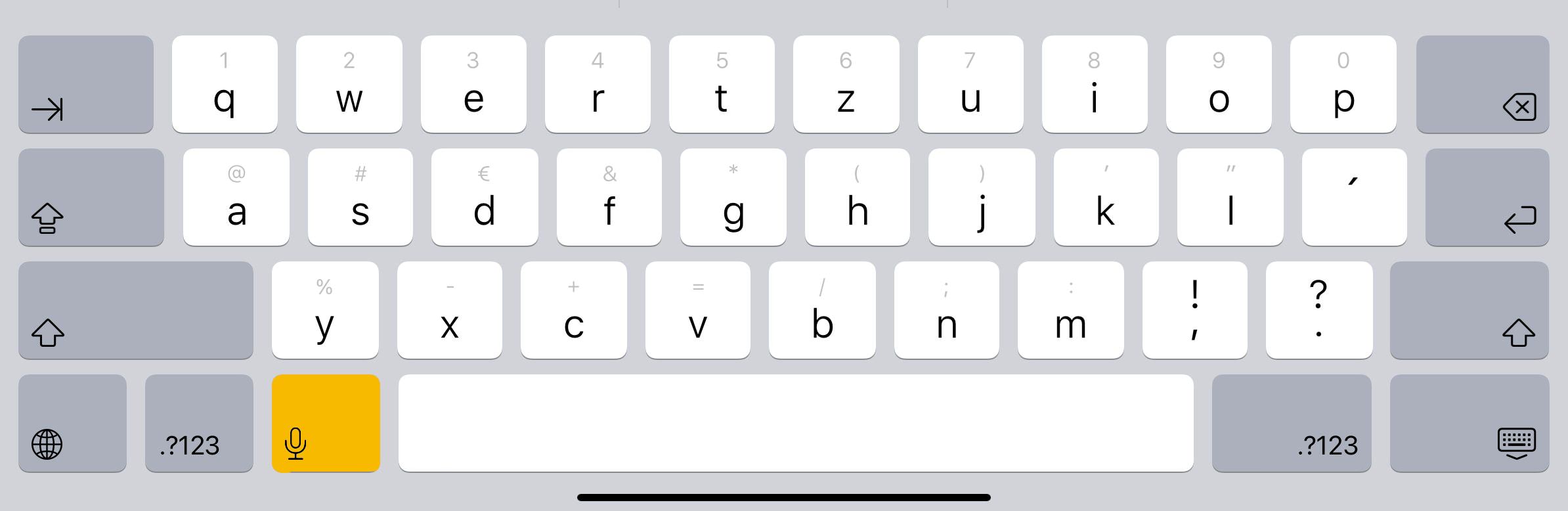 iOS keyboard with the microphone highlighted in yellow