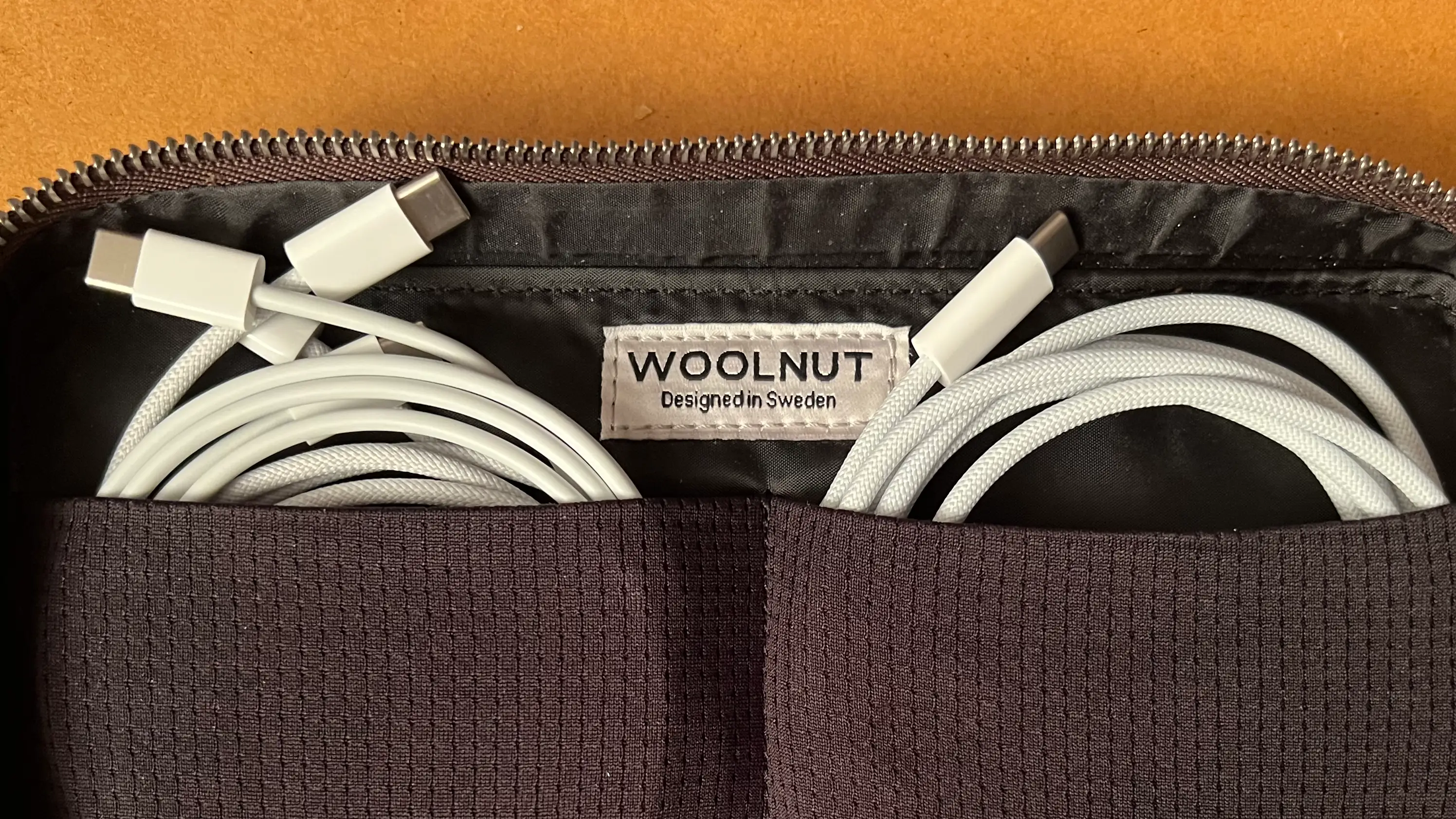 Woolnut Leather Tech Organizer open with USB cables stored in two separate pockets