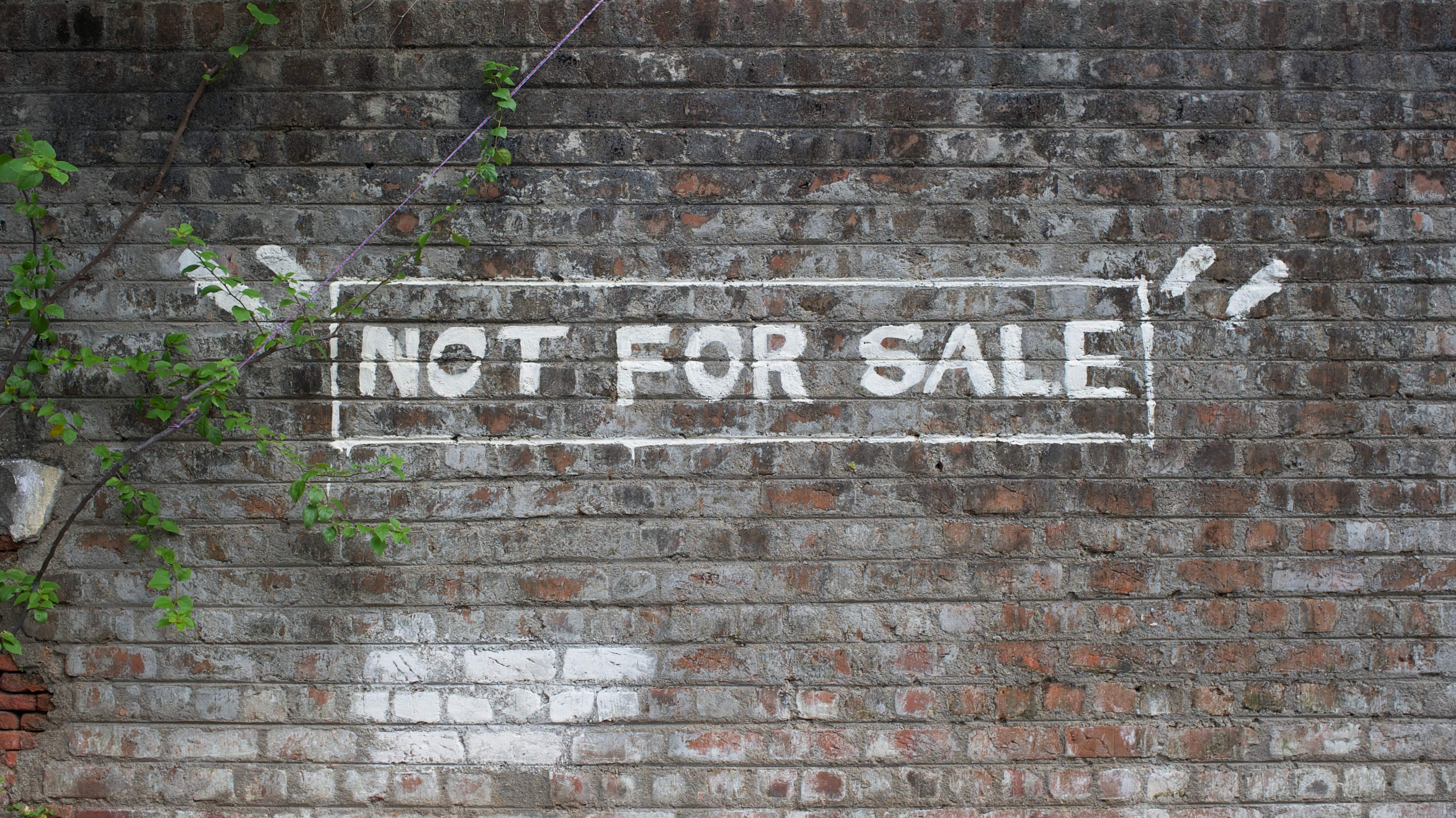 Not for sale painted in white letters on a brick wall in Pondicherry