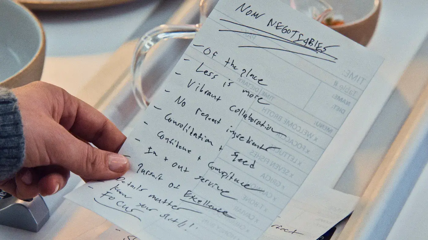 Nath's left hand holding the handwritten list at the beginning of episode 2